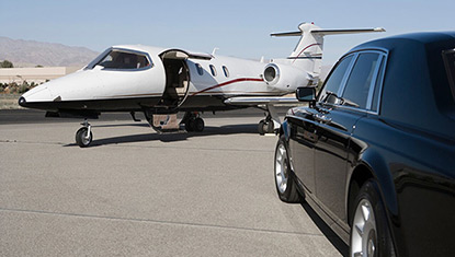 Limousine and Learjet on airport ramp